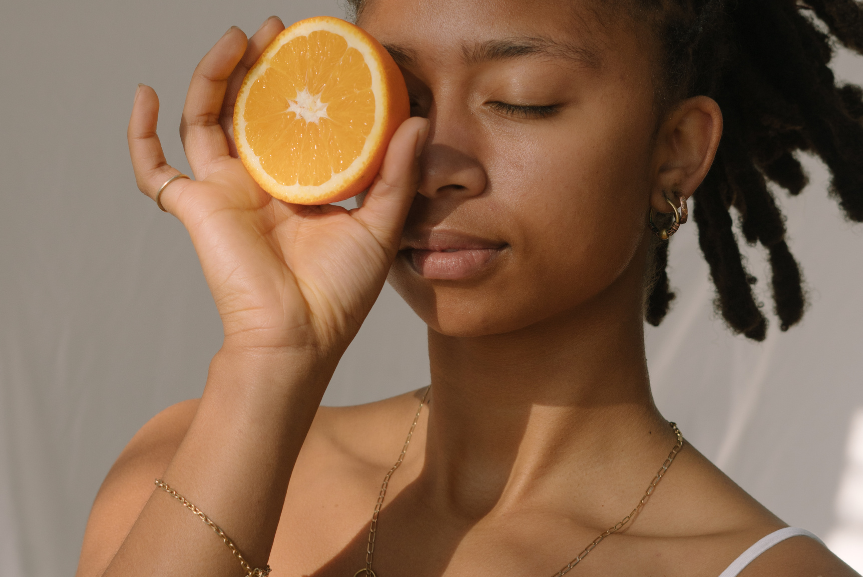 Woman Holding a Slice of Orange